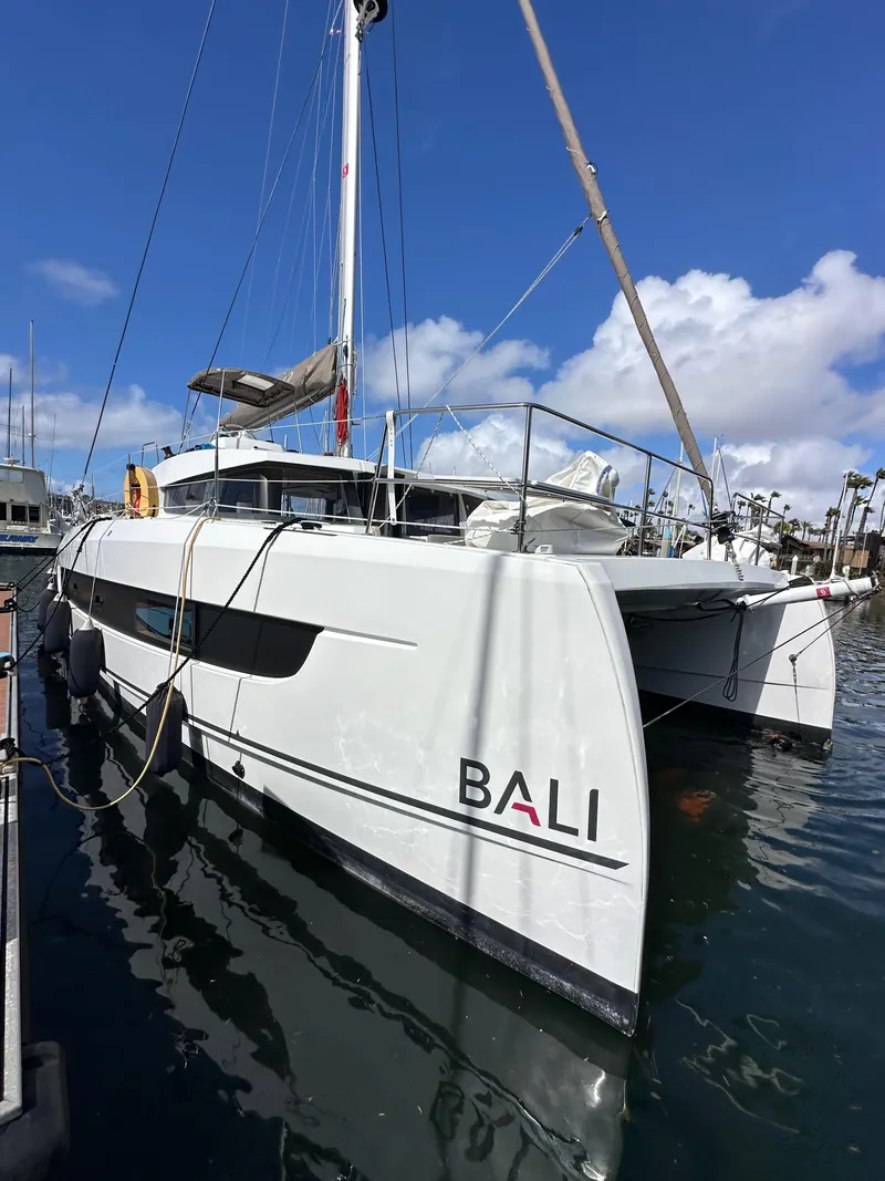 Slide: The Image of 2023 Bali 4.2 catamaran docked in marina under clear blue sky. - 4