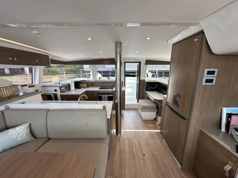 Slide: The Image of Interior of 2023 Bali 4.2 yacht, featuring modern kitchen and seating area with wood finishes. - 41