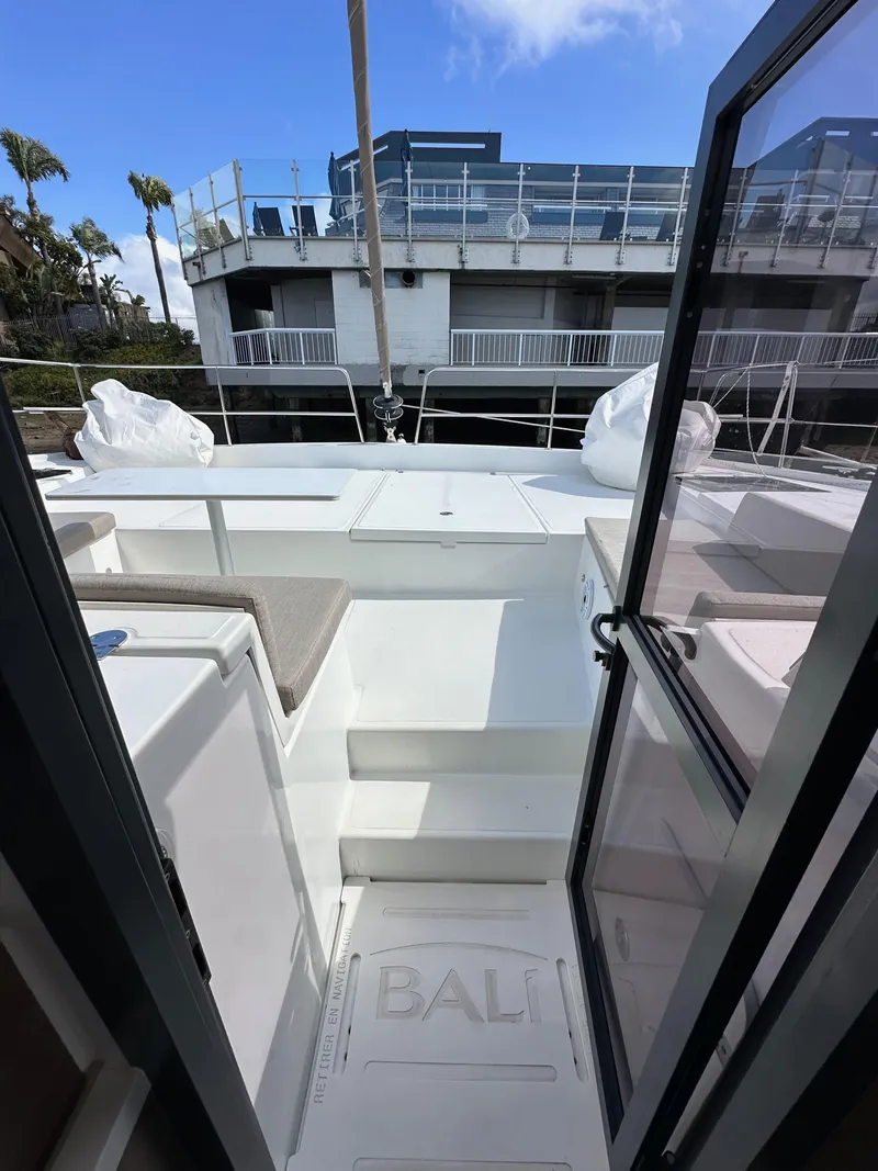Slide: The Image of 2023 Bali 4.2 yacht deck view with open doors and modern design. - 49