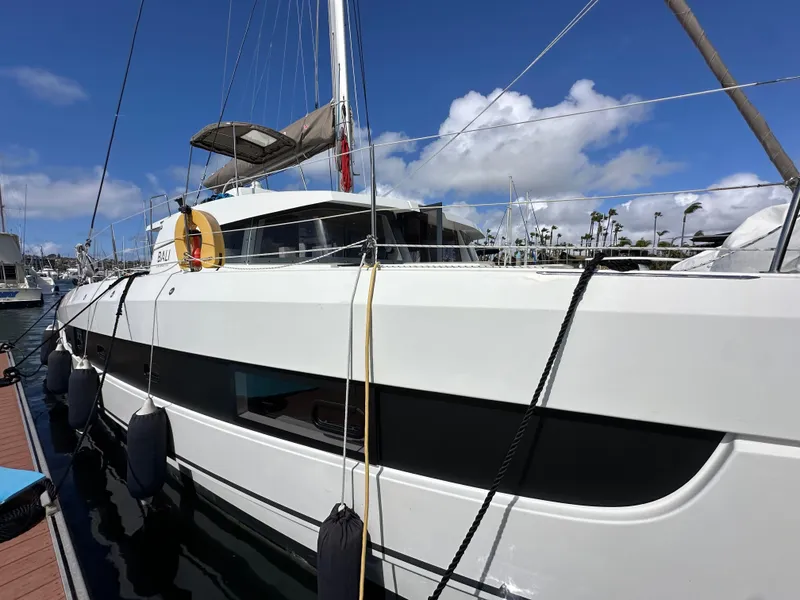 Slide: The Image of 2023 Bali 4.2 catamaran docked at marina under clear blue sky. - 5