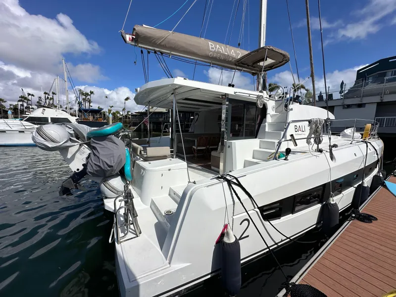 Slide: The Image of Modern Bali 4.2 catamaran docked at marina, showcasing sleek design and spacious deck. - 7