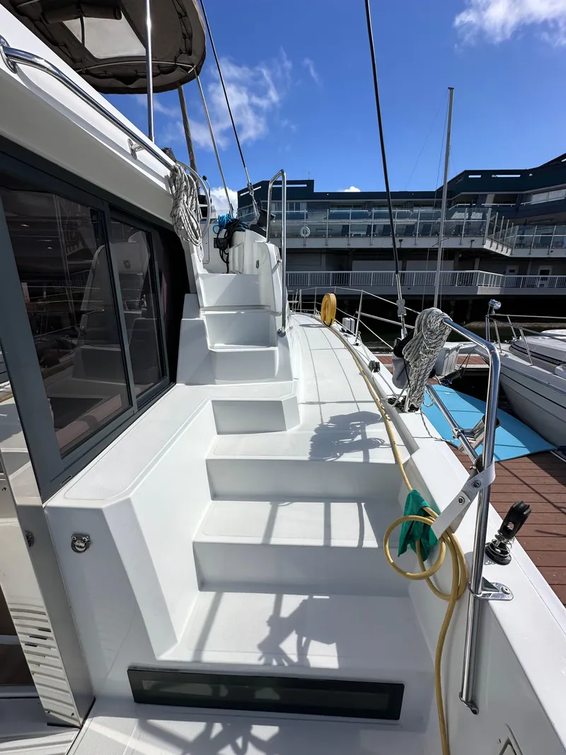 Slide: The Image of 2023 Bali 4.2 yacht deck with steps, docked at marina under clear blue sky. - 9
