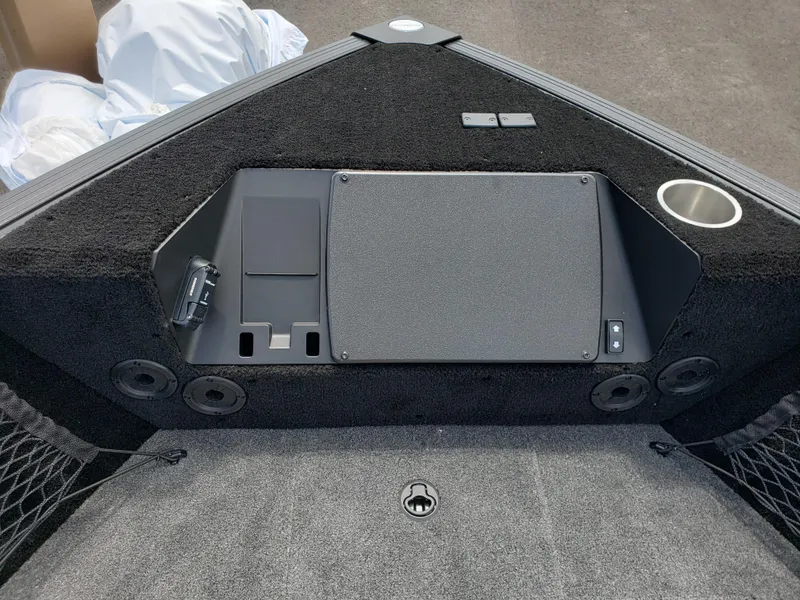 Slide: The Image of 2025 Alumacraft Competitor 185X Sport boat interior with storage compartments and cup holder. - 8