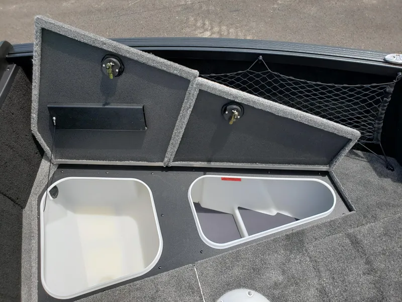 Slide: The Image of 2025 Alumacraft Competitor 185X Sport boat storage compartments with open lids and netting. - 9