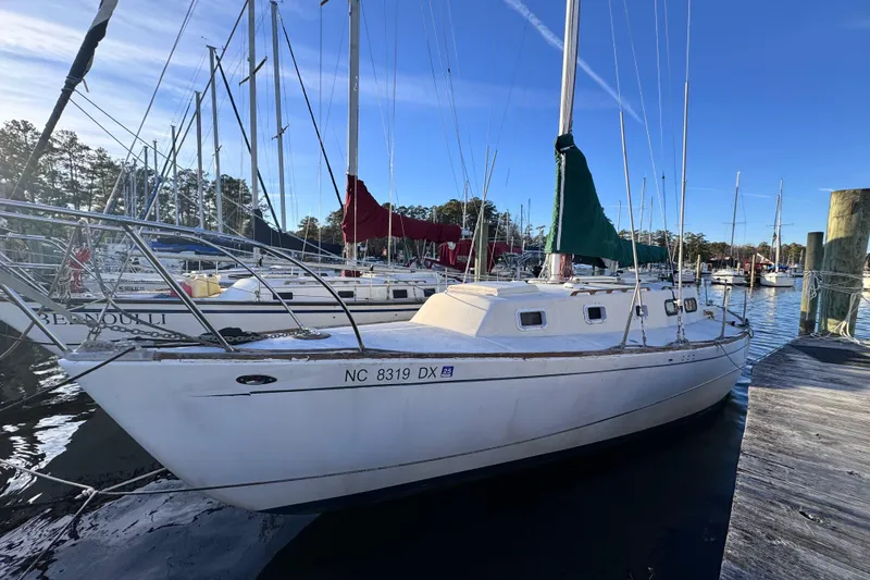 The Image of 1972 Morgan 35 sailboat docked at marina, clear blue sky, calm waters. - 0