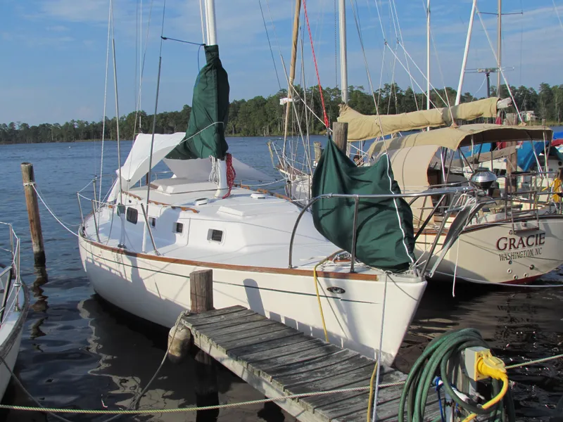 Slide: The Image of Interior of a 1972 Morgan 35 sailboat with wooden steps and a fire extinguisher. - 14