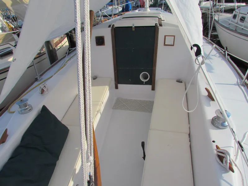 Slide: The Image of Interior of a 1972 Morgan 35 sailboat with cozy seating and compact kitchen area. - 17