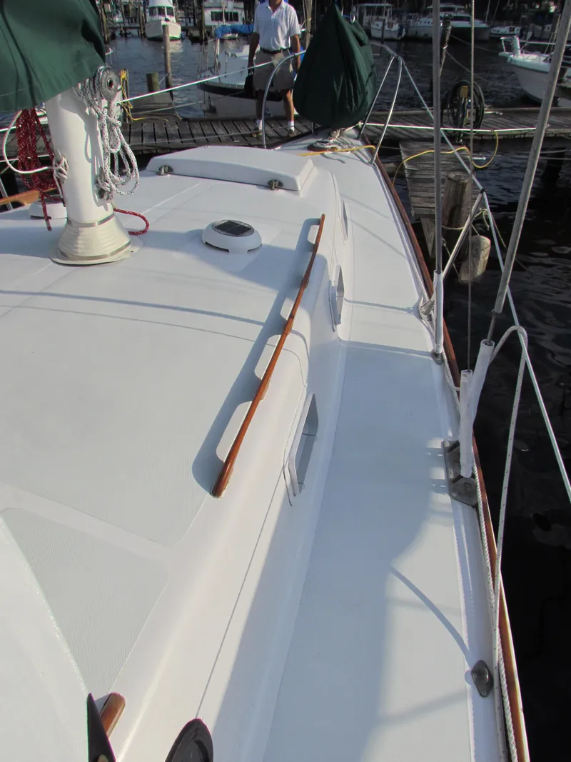 Slide: The Image of 1972 Morgan 35 sailboat docked at a marina, surrounded by other boats. - 3