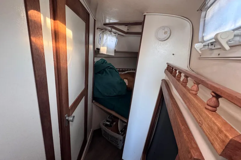 Slide: The Image of Interior cabin of a 1972 Morgan 35 sailboat with wooden accents and storage space. - 36
