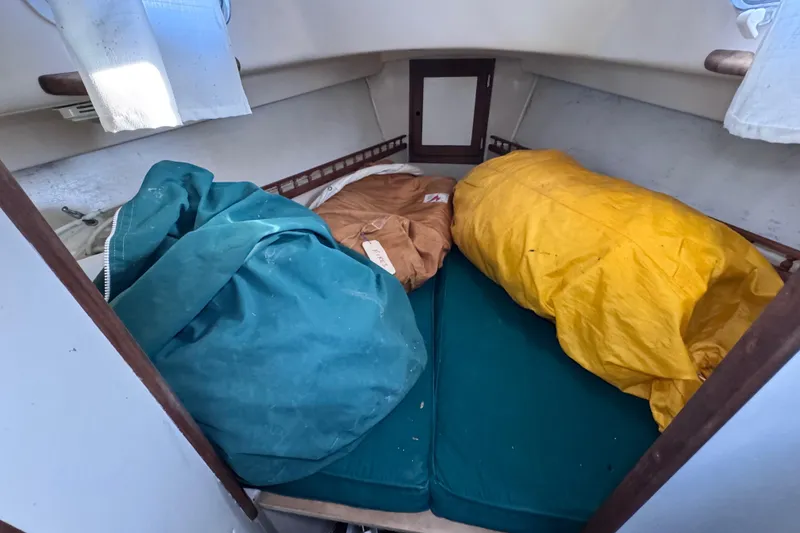 Slide: The Image of Interior of a 1972 Morgan 35 sailboat with colorful sleeping bags on a bed. - 38