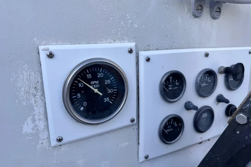 Slide: The Image of 1972 Morgan 35 boat dashboard with RPM and oil gauges. - 42