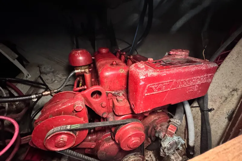 Slide: The Image of 1972 Morgan 35 engine compartment with red machinery and visible hoses. - 46