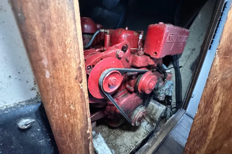 Slide: The Image of 1972 Morgan 35 engine compartment with red machinery and wooden framing. - 47