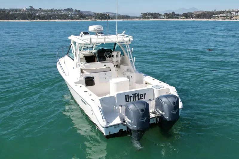 Slide: The Image of 2011 Pursuit 315 Offshore boat with twin Yamaha engines on open water. - 10