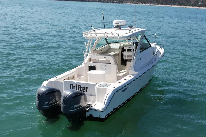 Slide: The Image of 2011 Pursuit 315 Offshore boat with twin Yamaha engines on calm water. - 11