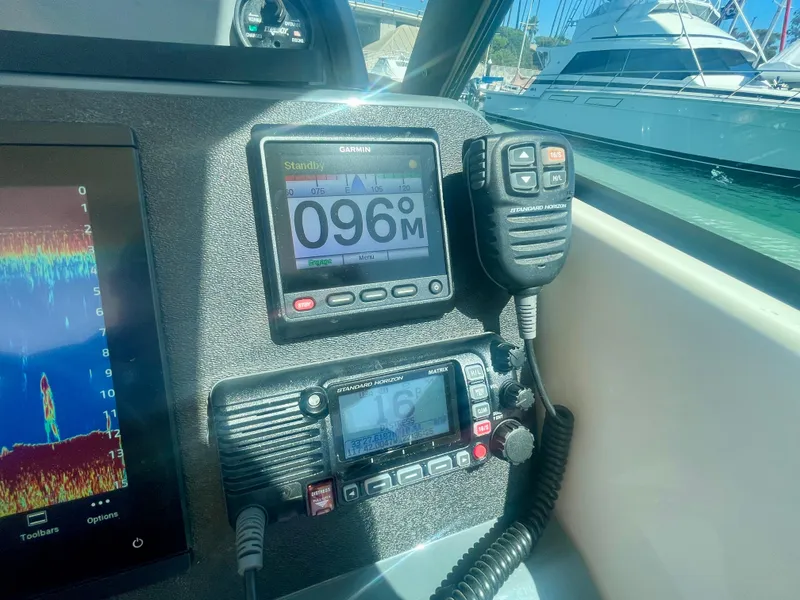 Slide: The Image of Boat dashboard with Garmin and Standard Horizon electronics on a 2011 Pursuit 315 Offshore. - 13