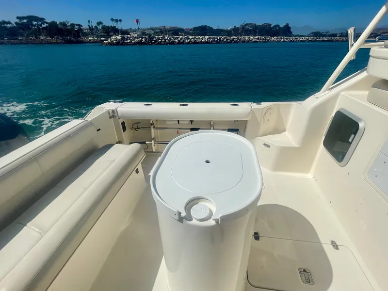 Slide: The Image of 2011 Pursuit 315 Offshore boat interior with seating and ocean view. - 17