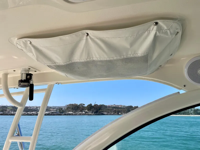 Slide: The Image of Interior view of a 2011 Pursuit 315 Offshore boat with ocean backdrop. - 22