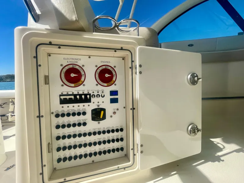Slide: The Image of Control panel on a 2011 Pursuit 315 Offshore boat, featuring electronics and engine switches. - 27