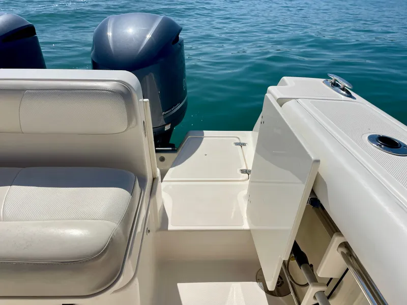 Slide: The Image of 2011 Pursuit 315 Offshore boat interior with seating and dual outboard motors. - 29