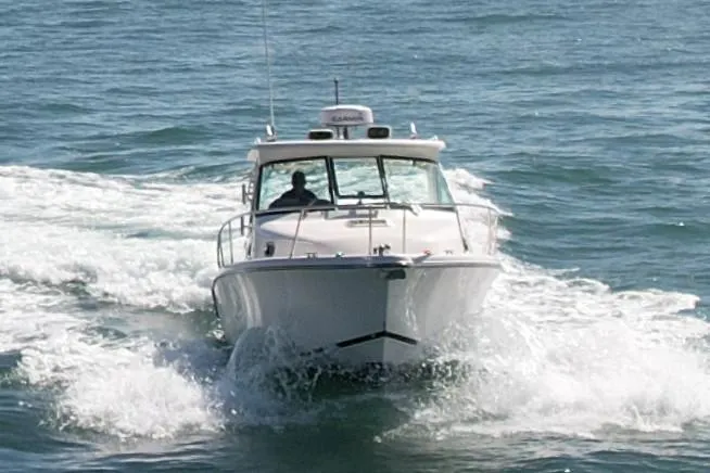 Slide: The Image of 2011 Pursuit 315 Offshore boat cruising on open water. - 3