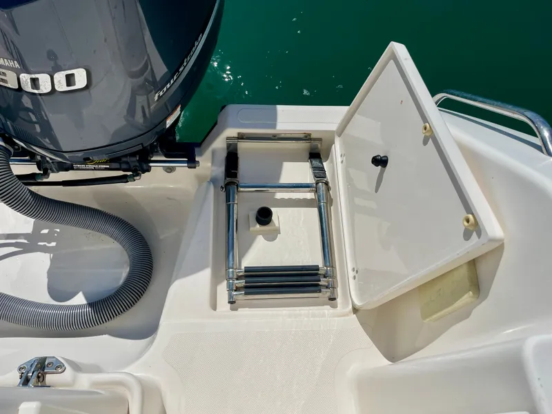 Slide: The Image of 2011 Pursuit 315 Offshore boat with Yamaha engine and foldable ladder. - 30