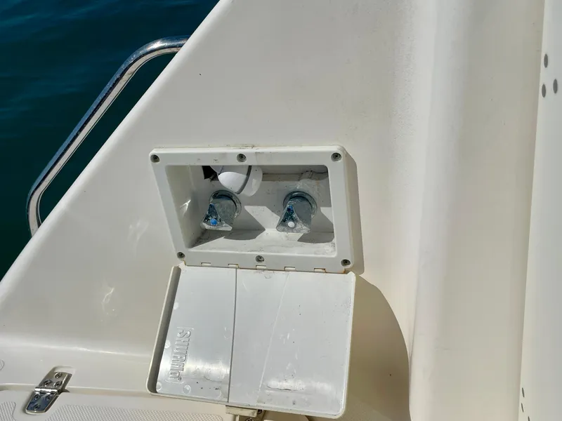 Slide: The Image of 2011 Pursuit 315 Offshore boat water connection panel with open cover. - 31