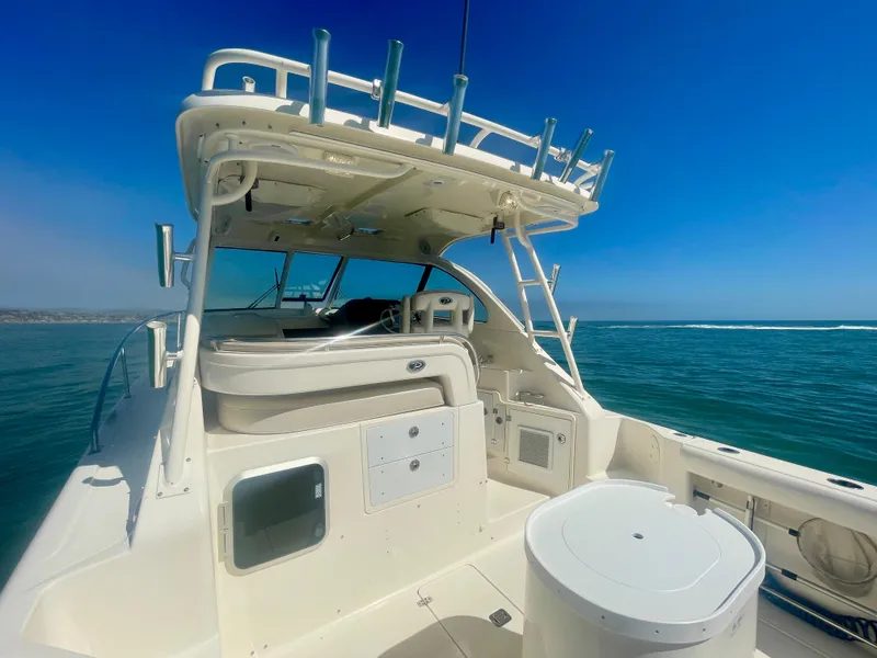 Slide: The Image of 2011 Pursuit 315 Offshore boat on open water under clear blue sky. - 32