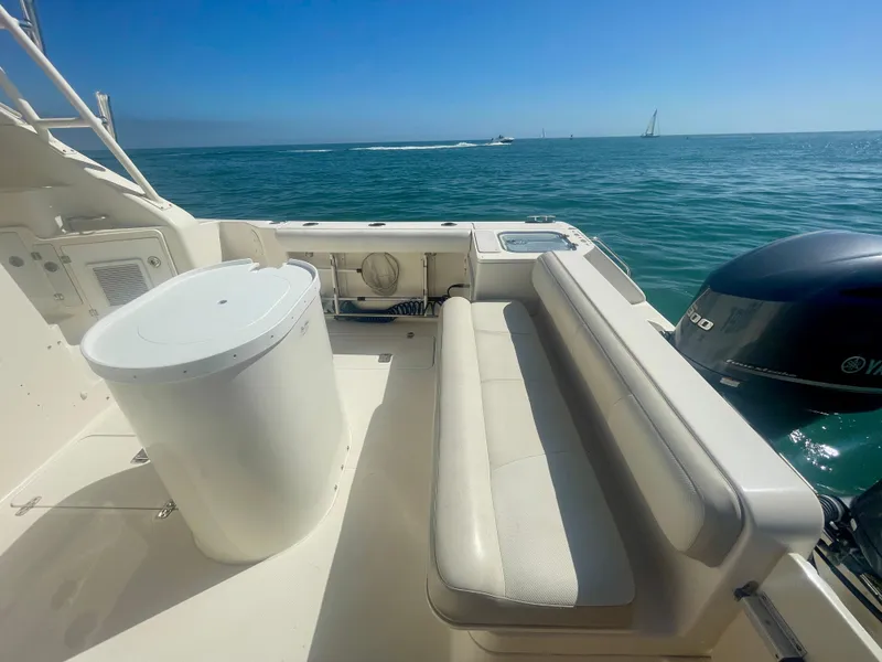 Slide: The Image of 2011 Pursuit 315 Offshore boat deck with seating, ocean view, and Yamaha engine. - 33