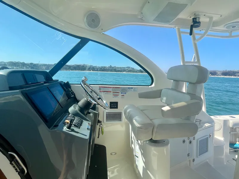 Slide: The Image of Helm of 2011 Pursuit 315 Offshore boat with ocean view and modern controls. - 35