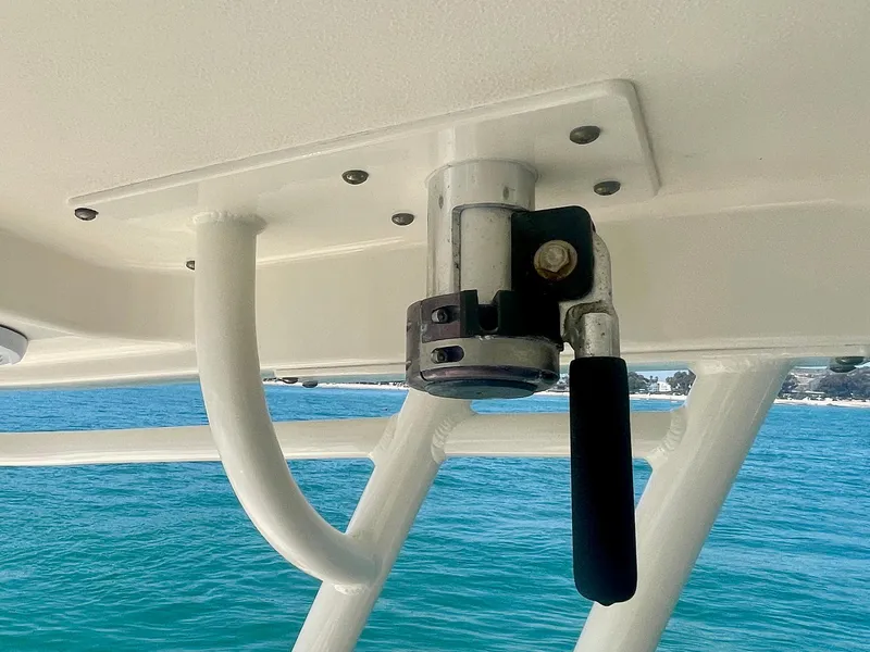 Slide: The Image of Close-up of a 2011 Pursuit 315 Offshore boat's handle mechanism against a blue ocean backdrop. - 37