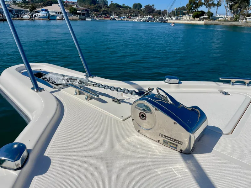 Slide: The Image of 2011 Pursuit 315 Offshore boat with anchor chain and Lewmar windlass in a marina setting. - 46