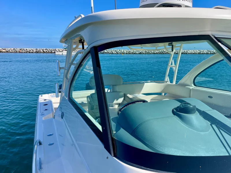 Slide: The Image of 2011 Pursuit 315 Offshore boat on calm blue water, sunny day. - 48