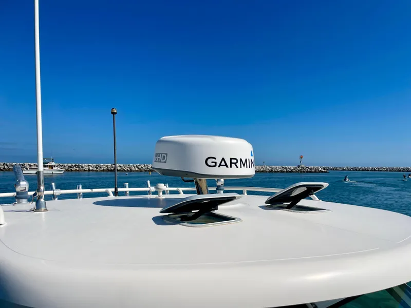 Slide: The Image of 2011 Pursuit 315 Offshore boat with Garmin radar on calm water. - 49