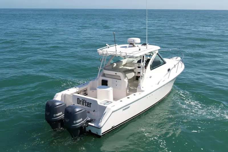 Slide: The Image of 2011 Pursuit 315 Offshore boat on open sea with twin Yamaha engines. - 5