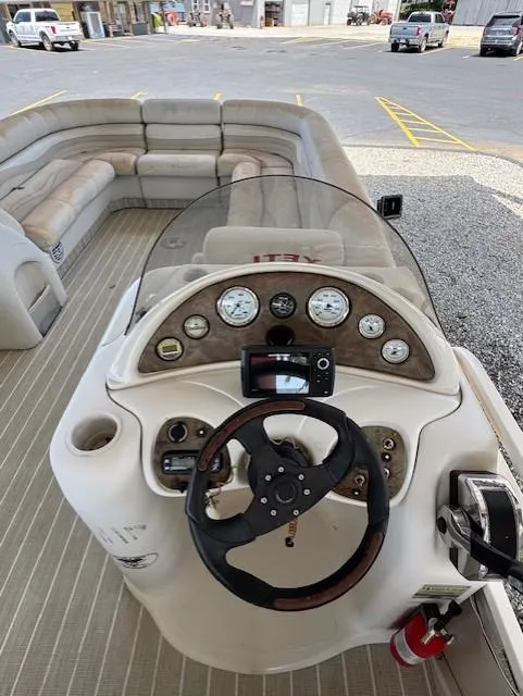 Slide: The Image of 2006 Starcraft Elite 246 RE CR boat dashboard with steering wheel and gauges. - 6