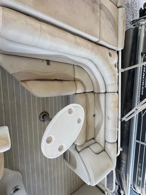 Slide: The Image of 2006 Starcraft Elite 246 RE CR boat interior with beige seating and round table. - 7