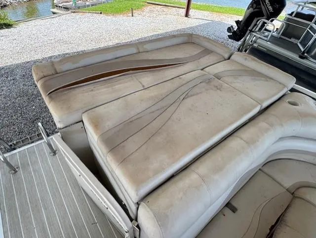 Slide: The Image of 2006 Starcraft Elite 246 RE CR boat interior with worn beige seating. - 8