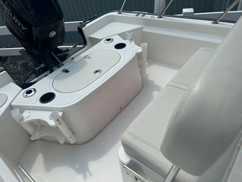 Slide: The Image of 2018 Boston Whaler 150 Montauk interior with seating and Mercury engine. - 10