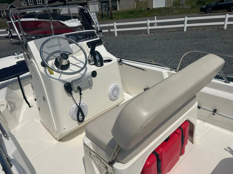 Slide: The Image of 2018 Boston Whaler 150 Montauk boat interior with Garmin steering and seating. - 11