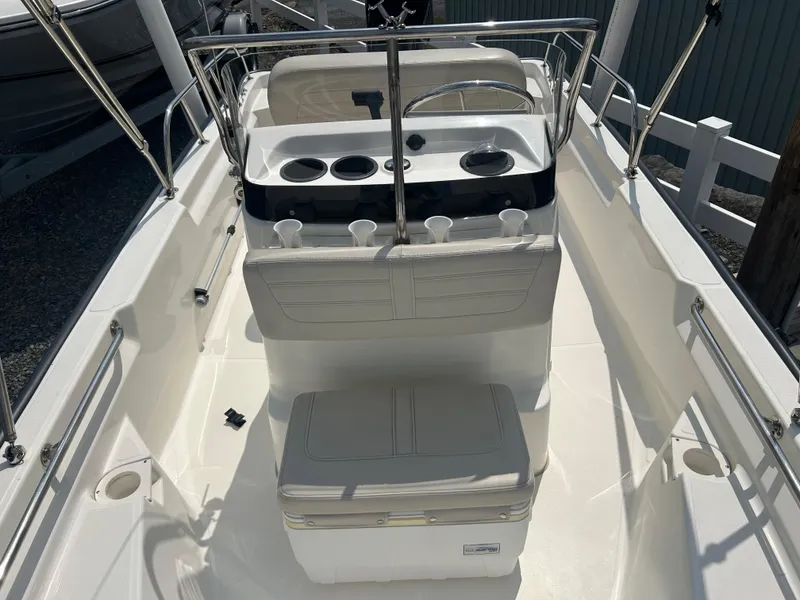 Slide: The Image of 2018 Boston Whaler 150 Montauk boat interior with seating and console. - 12