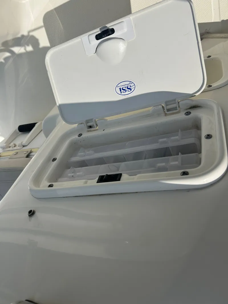 Slide: The Image of Open storage compartment on a 2018 Boston Whaler 150 Montauk boat. - 16