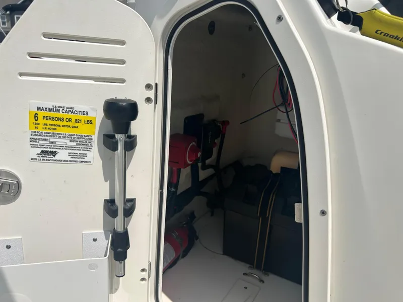 Slide: The Image of Boston Whaler 150 Montauk 2018 boat interior with capacity label and equipment storage. - 17