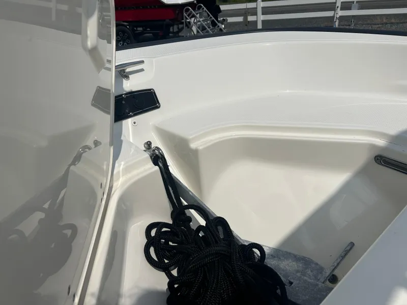 Slide: The Image of 2018 Boston Whaler 150 Montauk boat interior with coiled black rope. - 19