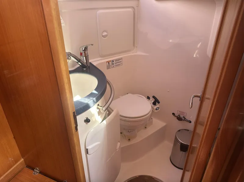 Slide: The Image of Compact bathroom in 2007 Bavaria 30 Cruiser yacht with sink and toilet. - 11