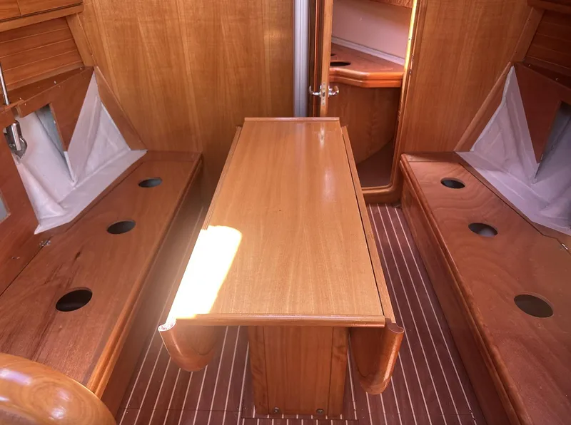 Slide: The Image of Interior of 2007 Bavaria 30 Cruiser sailboat with wooden seating and table. - 14