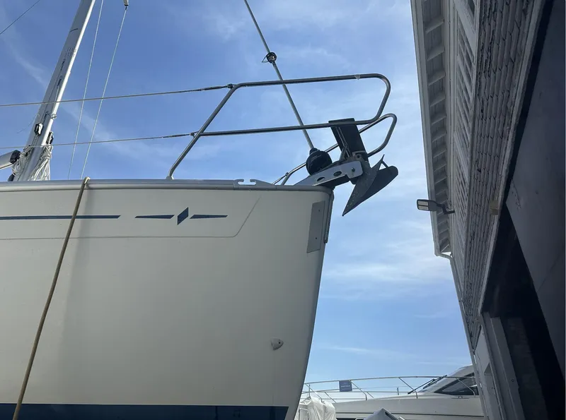 Slide: The Image of 2007 Bavaria 30 Cruiser sailboat bow with anchor, docked beside a building under a clear sky. - 3
