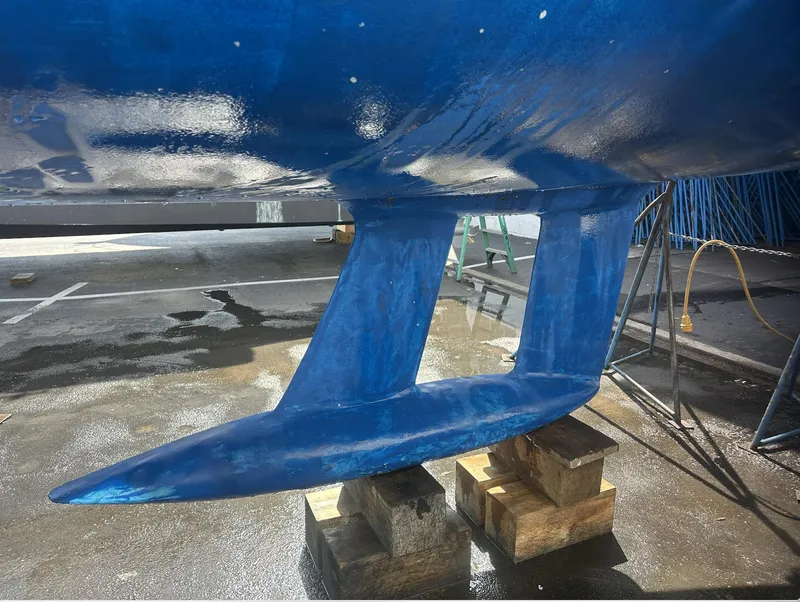 Slide: The Image of Blue keel of a 2007 Bavaria 30 Cruiser sailboat on wooden blocks. - 5