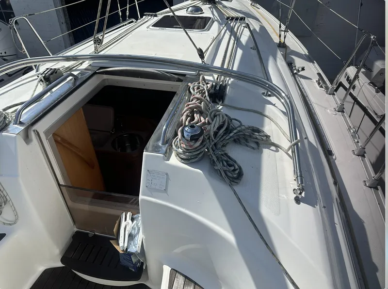 Slide: The Image of 2007 Bavaria 30 Cruiser sailboat deck with ropes and open cabin entrance. - 6