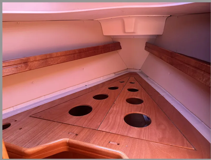Slide: The Image of Interior of 2007 Bavaria 30 Cruiser sailboat with wooden storage compartments. - 13